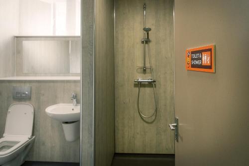 a bathroom with a shower and a toilet and a sink at Princes Street Hostel in Edinburgh