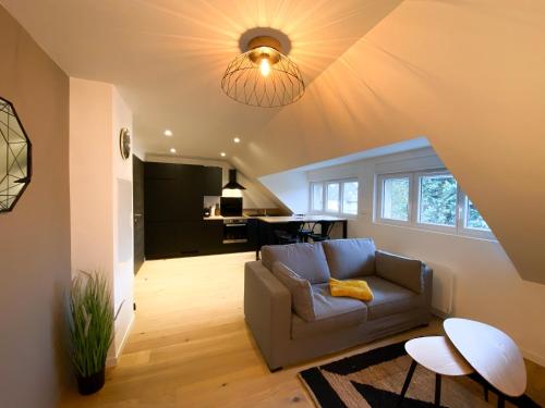 un soggiorno con divano e tavolo di WHITE HOUSE DHAVERNAS - PROCHE CENTRE - PARKING - WIFi HD ad Amiens