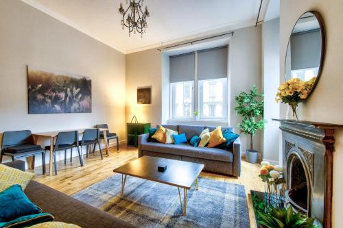 a living room with a couch and a table at Stylish & Spacious 3 Bedroom Apt in Finnieston, West End in Glasgow