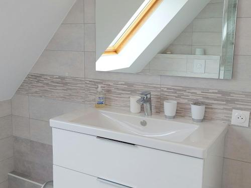 a white sink in a bathroom with a skylight at Cottage in Plouarzel in Plouarzel