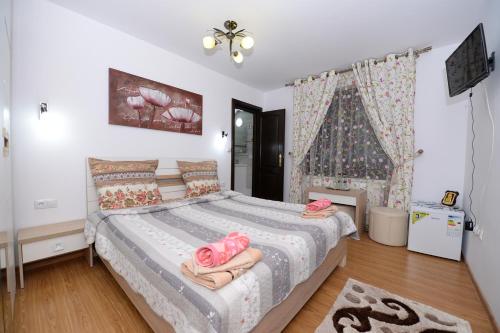 a bedroom with a bed with pink towels on it at Casa Teo&Andreea in Vatra Dornei