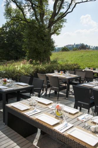 a group of tables and chairs on a patio at Taste Hotel Heidenheim in Heidenheim