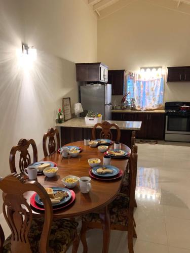 a kitchen with a wooden table with food on it at PARADISE VILLA SHAREd ONSITE PRIVATE POOL ONSITE GYM in Ocho Rios