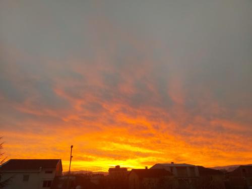 a sunset in a city with a cloudy sky at Art B in Ohrid