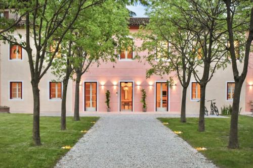 a pink house with trees in front of it at Villa Lovi in Bassano del Grappa
