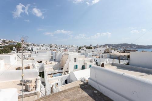 a view of a town with white buildings at aníko suites Chora in Mýkonos City