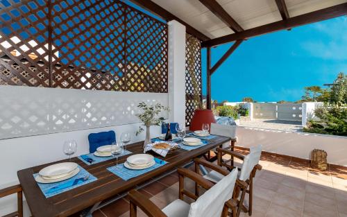 a dining room with a wooden table and chairs at Evilion Villa in Gennadi