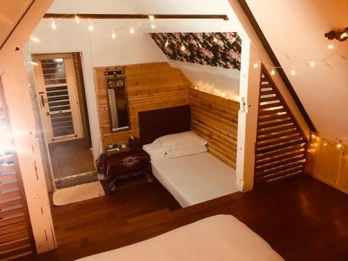 a room with a bed and a staircase with lights at Bridge12th B&B in Yanliau