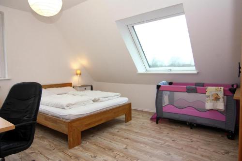 a bedroom with a bed and a window and a chair at Vacation home, Neukirchen in Neukirchen