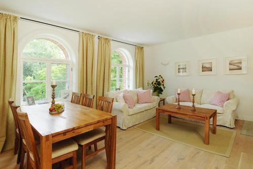 a living room with a table and a couch at Gutshaus Zicker in Garz in Garz-Rügen