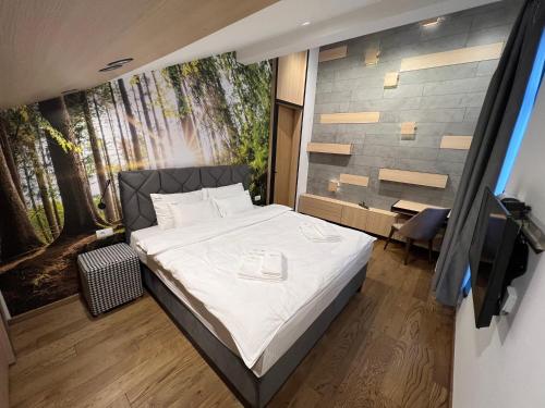 Ένα ή περισσότερα κρεβάτια σε δωμάτιο στο FORRESTO APARTMANI JAHORINA