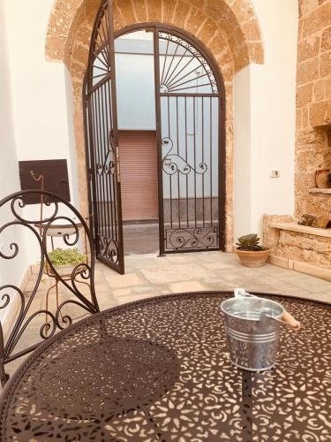 a large iron gate with a table in front of a door at Nonna Veronica in Gemini