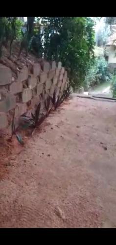 a stone wall sitting next to a road at Casa Vista al Mar in Morro de São Paulo