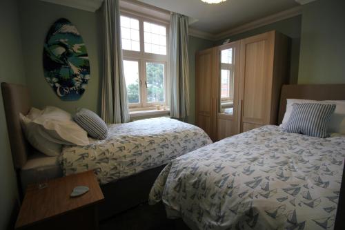 a hotel room with two beds and a window at Bournemouth Reef Apartment in Bournemouth