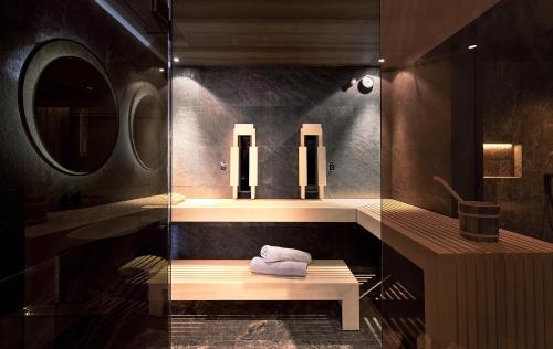 a bathroom with a sink and a mirror at Wellness- & Sporthotel Jagdhof in Röhrnbach
