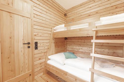 a wooden cabin with two bunk beds in it at Ferienhaus Spitzenhof - Urlaub am Bauernhof in Mooslandl