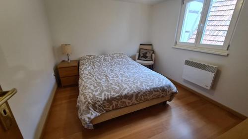 a small bedroom with a bed and a window at le bonheur est parfois cache dans l'inconnu in Sélestat