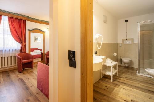 a bathroom with a sink and a toilet in a room at Hotel Bellavista in Cavalese