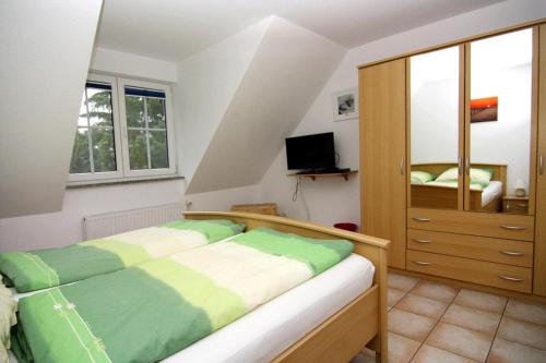 a bedroom with a bed and a dresser at Terraced house, Zingst in Zingst