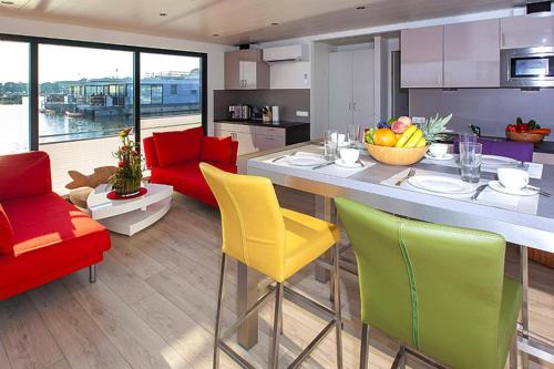 a kitchen with yellow and red chairs and a counter at Haus in Ribnitz Damgarten for 3 Personen in Ribnitz-Damgarten