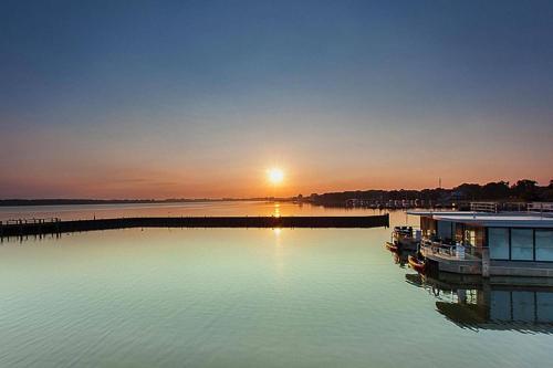 a sunset over a body of water with a dock at Haus in Ribnitz Damgarten for 3 Personen in Ribnitz-Damgarten
