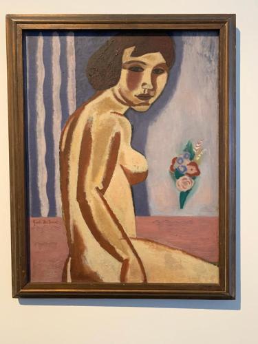 a painting of a woman with a hat on a wall at Belle de Nuit in Ostend
