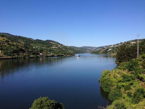 a view of a river with a boat in it at Alojamento das Caldas in Caldas de Aregos