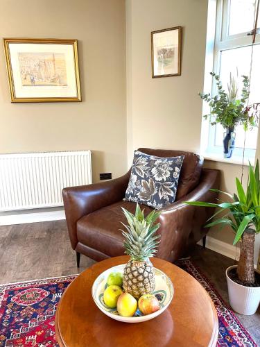 a living room with a bowl of fruit on a table at Luxurious two-bedroom apartment in the centre of Peterborough in Peterborough