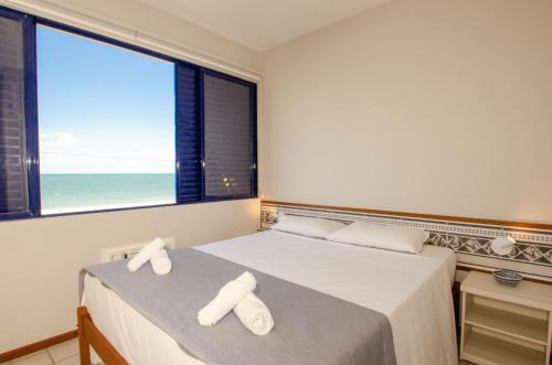 A bed or beds in a room at Apartamento frente mar em Canasvieiras N1177