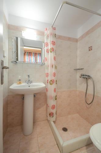 a bathroom with a sink and a shower at Vaso studios in town with parking in Naxos Chora