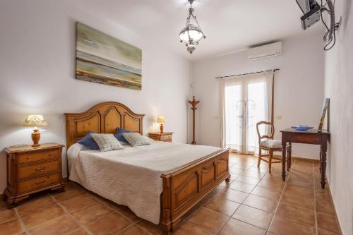 a bedroom with a bed and a table and a chair at Finca Coqueta in El Port de la Selva