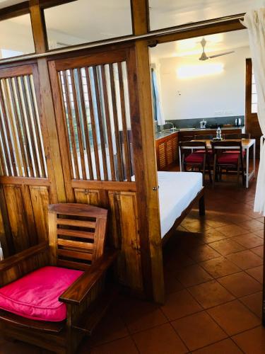 a room with a sauna with a bench and a table at The Canopy Guest House in Auroville