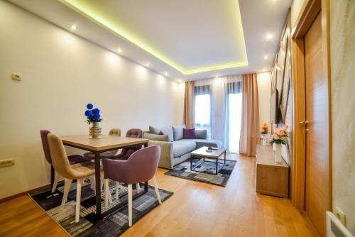 a living room with a table and a couch at Balkan Hill Zlatibor in Zlatibor