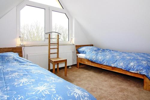 Ένα ή περισσότερα κρεβάτια σε δωμάτιο στο Ferienhaus in Vieregge mit Meeresstrand