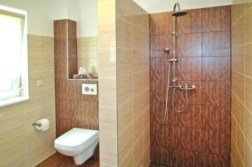uma casa de banho com um chuveiro e um WC. em Vacation home Spreeidyll, Schlepzig em Schlepzig