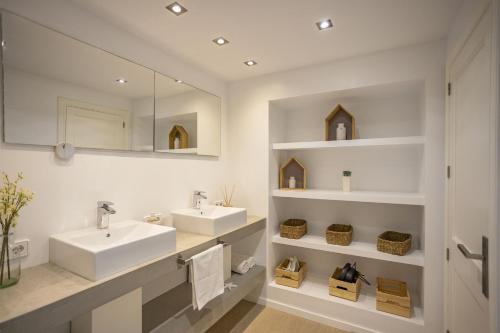 a bathroom with two sinks and a mirror at House Can Toni in Port d'Alcudia