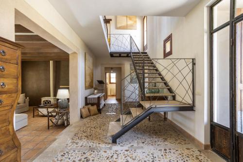 a hallway with a spiral staircase in a house at Villa Es Triquet Family in Binissalem