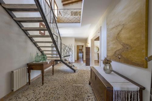 a hallway with a spiral staircase in a house at Villa Es Triquet Family in Binissalem