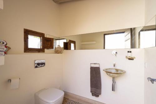 a bathroom with a toilet and a sink at Villa Es Triquet Family in Binissalem