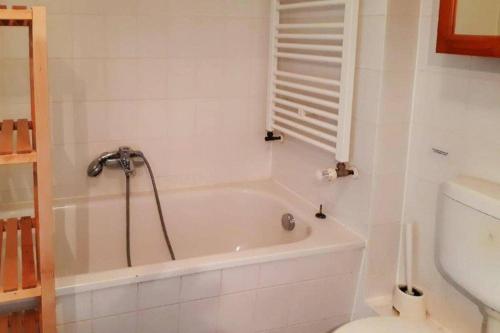 a white bathroom with a tub and a toilet at Ferienwohnungen Blaues Haus, Putbus in Putbus