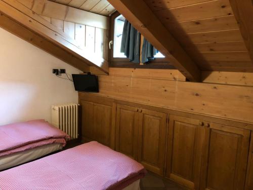 a room with two beds and a window at Hotel Compagnoni in Santa Caterina Valfurva