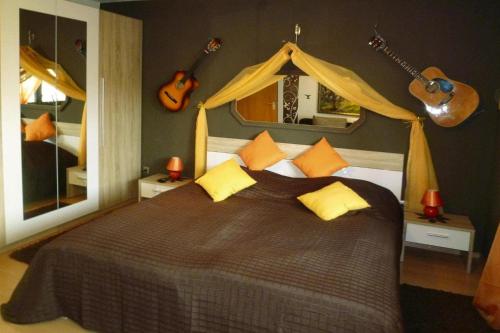 ein Schlafzimmer mit einem großen Bett mit Gitarren an der Wand in der Unterkunft Apartment, Oberdorf near Langenargen in Oberdorf