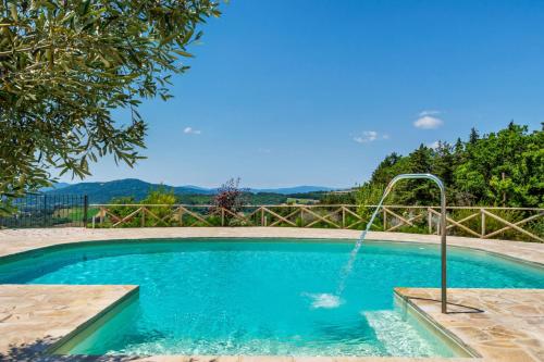 a swimming pool with a water fountain at Villa Morotti by Mmega in Montone