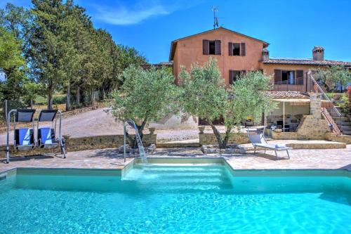 a swimming pool in front of a house at Villa Morotti by Mmega in Montone