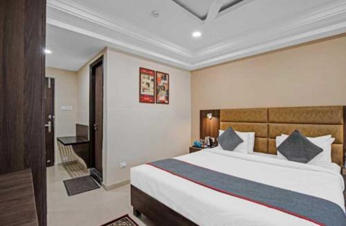a bedroom with a large bed in a room at Alba Premier, Ahmedabad in Ahmedabad