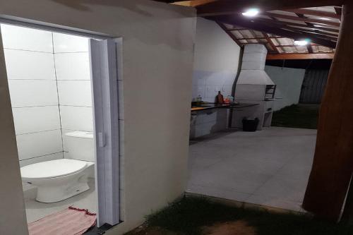 a bathroom with a toilet in a room at Dream House in Itacimirim