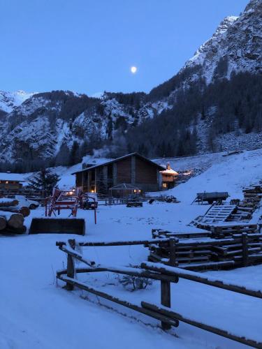 a cabin in the snow with a mountain at La Ferme du Grand Paradis in Cogne