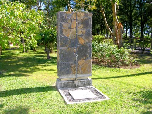 a stone statue in the grass in a park at Kenville in Bain Boeuf
