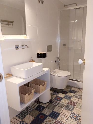 a bathroom with a sink and a toilet at Casa da Umbria in Odemira