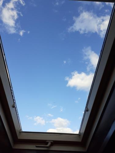 a window in a room with a blue sky at The view attic in Ioannina